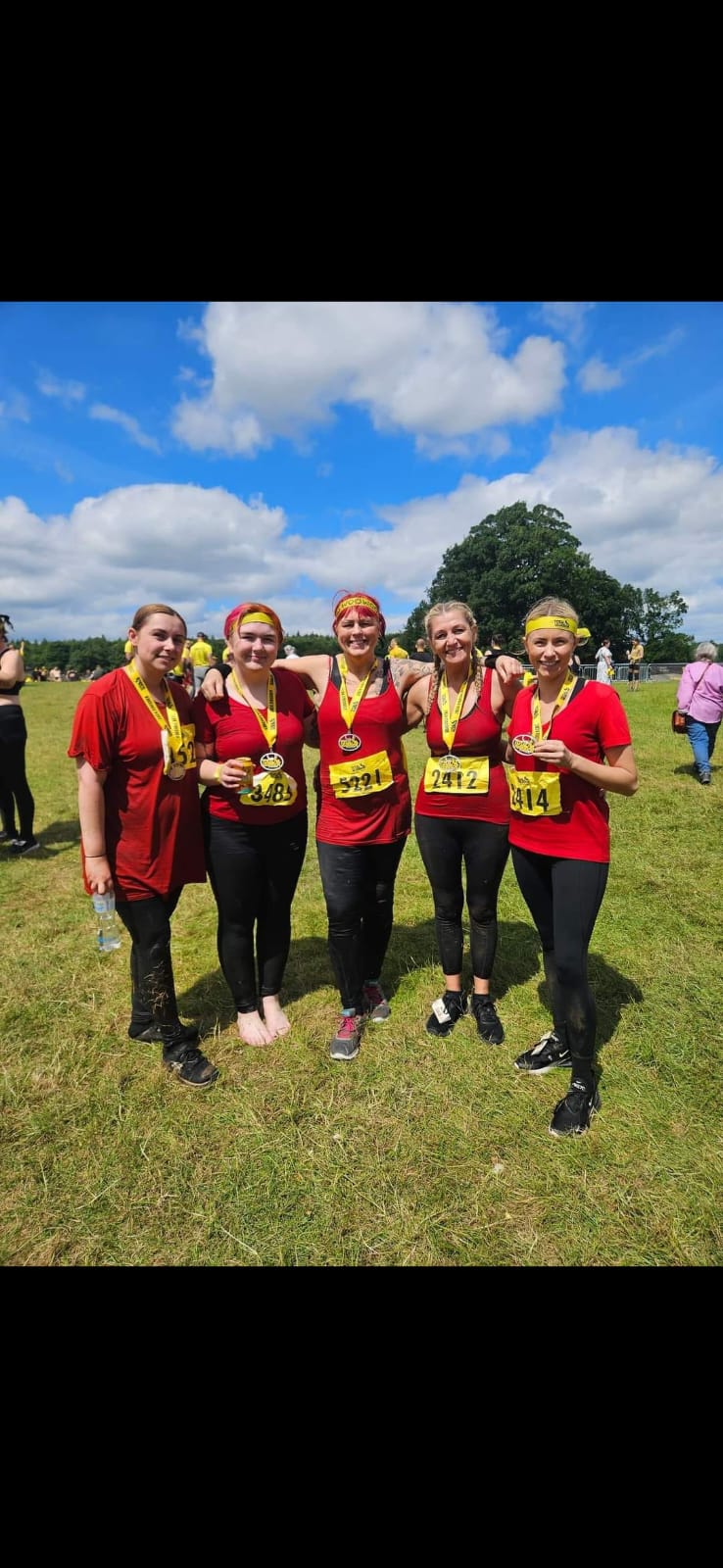 Stella's team at charity run event with medals